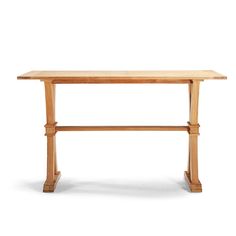 a wooden table sitting on top of a white floor