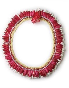 a red and white beaded necklace with pink flowers on the front, gold chain around it