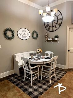 a dining room table with chairs and a clock on the wall in the back ground