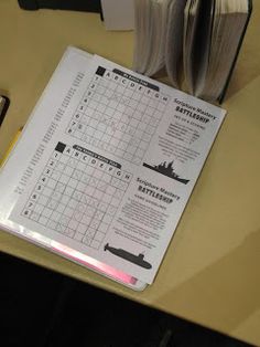 a table with a calendar, pen and cell phone on it next to an open book