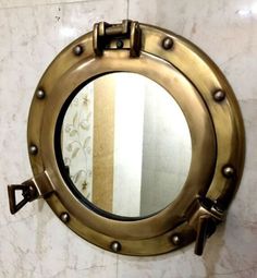 a round mirror mounted to the side of a wall