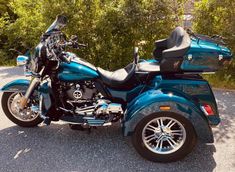 a blue motorcycle is parked on the side of the road