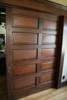 a large wooden door in the middle of a room