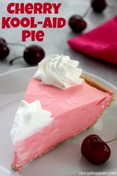 a slice of cherry kool - aid pie on a plate with cherries