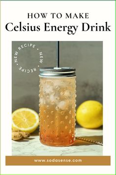 a mason jar filled with liquid next to lemons