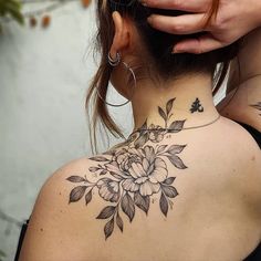 a woman with a flower tattoo on her neck