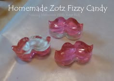 three pink and white candy candies sitting on top of a paper towel with the words homemade zotz fizzy candy