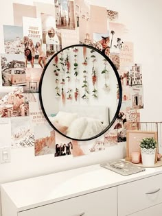 a white dresser topped with lots of drawers and a mirror on the wall above it