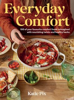 the cover of everyday comfort magazine with a woman preparing food in a large skillet