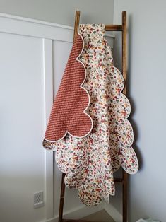 a ladder with two towels hanging from it's side