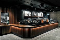 the interior of a coffee shop with wood paneling on the walls and counter tops