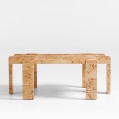 two wooden benches sitting next to each other on top of a white floor covered in dirt