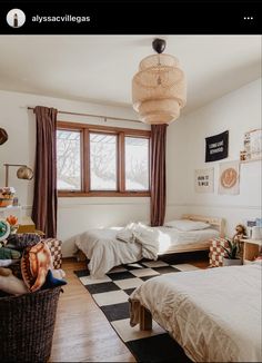 a bedroom with two beds and a checkered rug