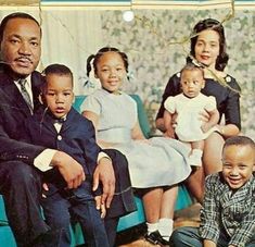 an old photo of a family sitting on a couch