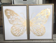 two framed pictures with gold butterflies on them