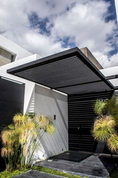 a black and white house with grass in the front yard