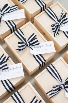 many small boxes with black and white ribbons tied around the edges, each containing a name tag