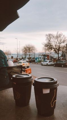 two coffee cups sitting on top of a table