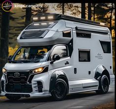 a white motor home driving down a road