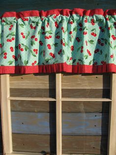 the window valance has cherries on it