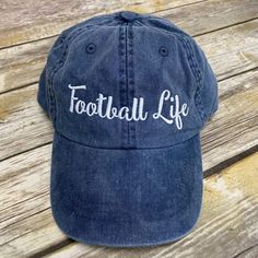 A must have hat for every football fan! Perfect for anyone that lives that football life. Even great for football moms or even coaches. Plus this hat has a great vintage look to it. Hat comes with Football Life on the front of the hat in embroidery. Football Gift!