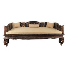 an antique style daybed with pillows on it's sides and back rests against a white background