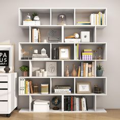 a white book shelf filled with books on top of a hard wood floor next to a dresser