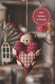 a teddy bear holding a heart hanging from a string with the words pop pattern and tutor above it