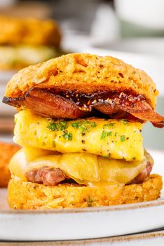 a bacon and egg breakfast sandwich on a plate