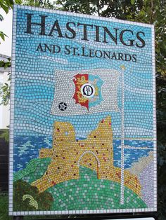 a mosaic sign with the words hastings and standards on it in front of some trees