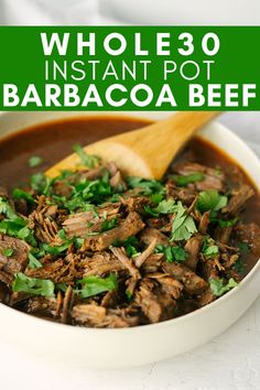 a white bowl filled with meat and garnished with cilantro