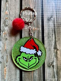 a keychain with the grin face on it and a red pom - pom