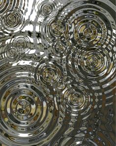 an abstract image of silver circles on a metal surface