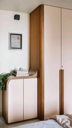 a bed room with a neatly made bed and cupboards