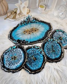 four pieces of blue agate glass on a white furnishing