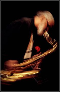 a blurry image of a man playing the trumpet