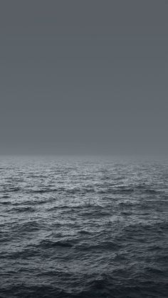 the ocean is very dark and empty with no people on it or any other boat