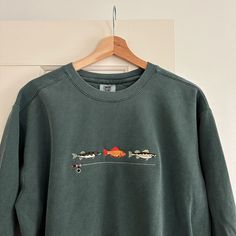 This listing is for a pre-order. Any order containing this item can be expected to ship between 01/22 - 01/28.   Embroidered Crewneck | Comfort Colors Sizes are relaxed unisex size. Material: 80% cotton and 20% polyester Crew Neck Upcycle, Embroidery Designs For Crewnecks, $20 Christmas Gifts, Coastal Grandpa Style, Embroided Sweaters, Men’s Embroidered Sweatshirt, Embroidered Fish Simple, Cute Thrifted Outfit Ideas, Embroidery Gifts For Men