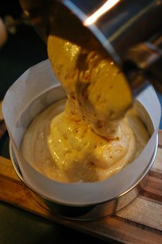 a person scooping some food into a bowl