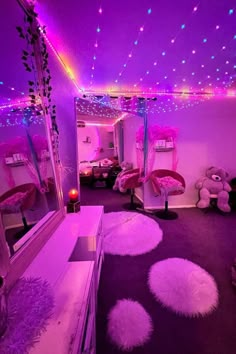 a room with purple lights and pink furniture in it's center area, along with white fluffy rugs on the floor