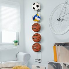 The perfect addition to any gym, garage, or shed this wall mounted black metal sports ball storage racks keeping your space neat, tidy and stylish. Simply mount to most wall surfaces with proper mounting hardware to easily store and conveniently access your basketballs, soccer balls, volleyballs, footballs, or sports and medicine balls or even kettle bells. With six metal rings you will double your storage, and create more floor space while keeping your sports and exercise balls from rolling aro Sports Wall Storage, Sports Boys Room Walmart, Ball Wall Shelf, Boys Sports Room Walmart, Boys Trainer Storage, Swiss Ball Storage, Bedroom Sport, Sports Ball Storage, Soccer Bedroom