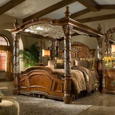 a large wooden bed sitting inside of a bedroom