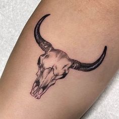 a bull's head tattoo on the right arm is shown in black and white