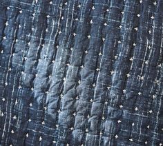 an old quilt with white stars on blue fabric, close - up view from the bottom