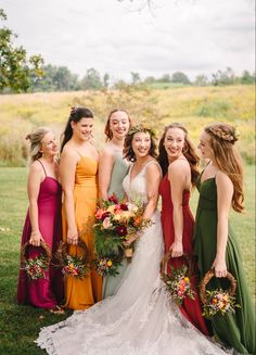 a group of women standing next to each other on top of a lush green field