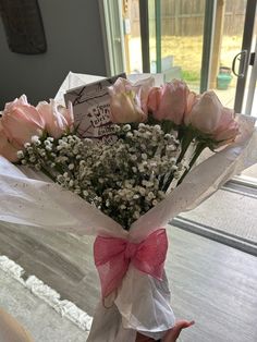 a bouquet of flowers in someone's hand