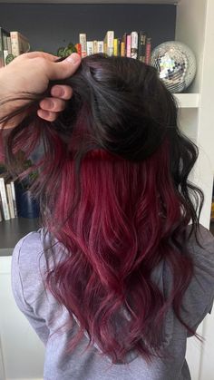 This undercolor block combo is giving all the rich, sultry vibes! The deep plum on top flows into a hidden cherry wine pop underneath, creating the perfect blend of bold and subtle. Whether you're wearing it sleek or letting it flow, this look brings a touch of mystery with every flip. 🍷✨ Wine Red Hair Underneath, Maroon Underdye Hair, Dark Hair Red Underneath, Magenta Peekaboo Highlights, Peekaboo Hair Color Burgundy, Wine Red Hair With Money Pieces, Brown And Maroon Hair, Cherry Red Hair Underneath, Cherry Red Peekaboo Hair