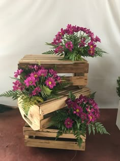 three wooden pallets with purple flowers in them