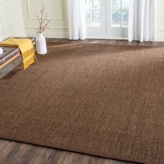 a brown area rug in a living room