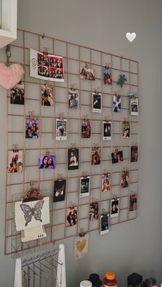 a wall with pictures and magnets attached to the back of it in a room